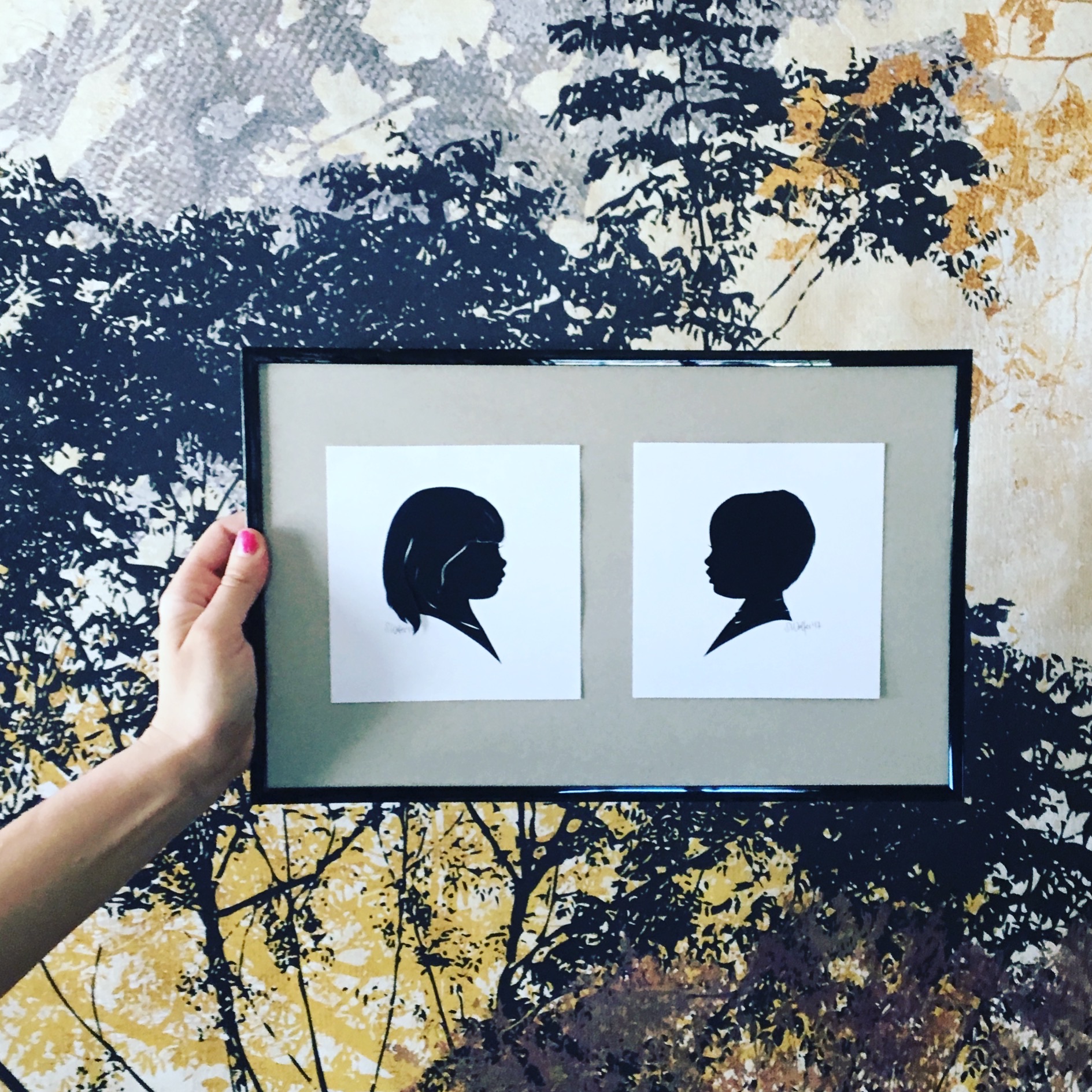 Hand cut silhouette of boy and girl